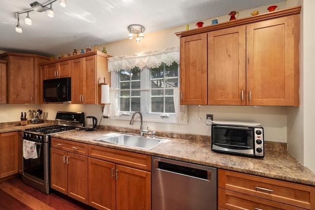 84 Chapin Greene Unit 84, Ludlow, MA 01056 - kitchen featuring appliances with stainless steel finishes, brown cabinetry, and dark wood-style floors