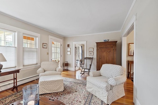 4 Pleasant View St, Methuen, MA 01844 - sitting room featuring a baseboard heating unit, ornamental molding, wood finished floors, and baseboards