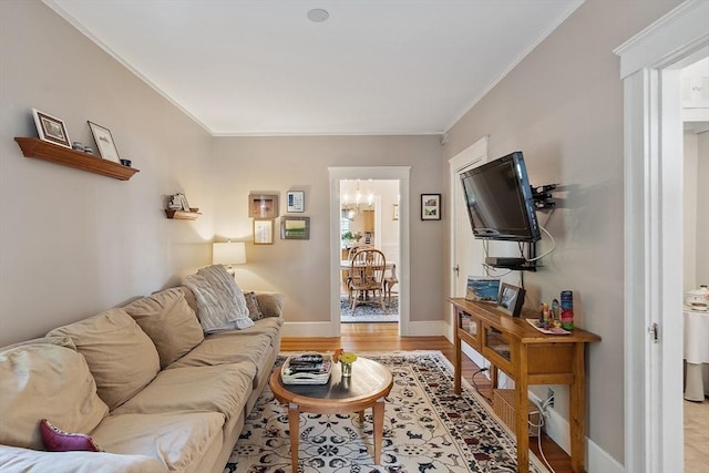 4 Pleasant View St, Methuen, MA 01844 - living room featuring light wood-style floors, a chandelier, crown molding, and baseboards