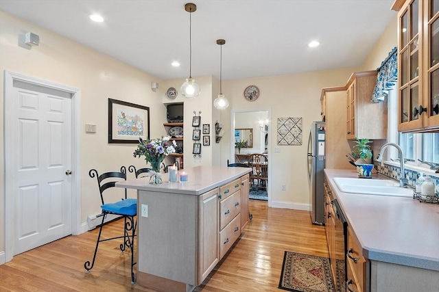 4 Pleasant View St, Methuen, MA 01844 - kitchen featuring freestanding refrigerator, a sink, a breakfast bar, a kitchen island, and light wood-style flooring