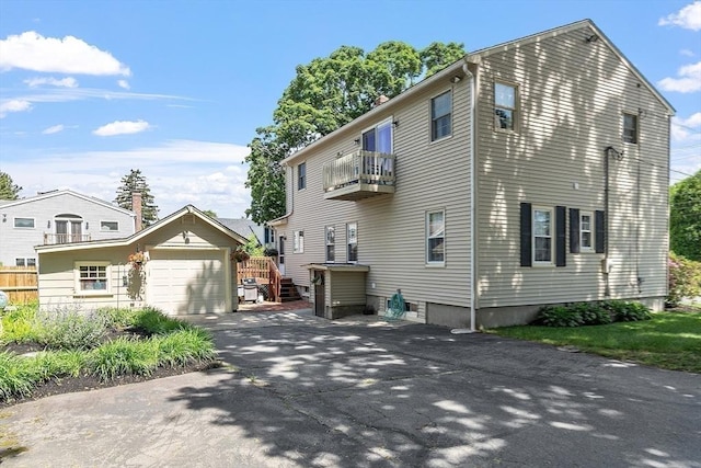 4 Pleasant View St, Methuen, MA 01844 - view of home's exterior featuring a balcony, driveway, an attached garage, and an outbuilding