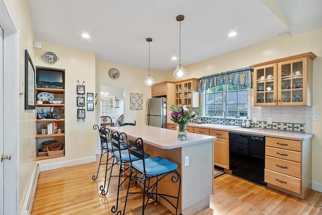 4 Pleasant View St, Methuen, MA 01844 - kitchen featuring black dishwasher, freestanding refrigerator, a sink, a baseboard heating unit, and a kitchen breakfast bar