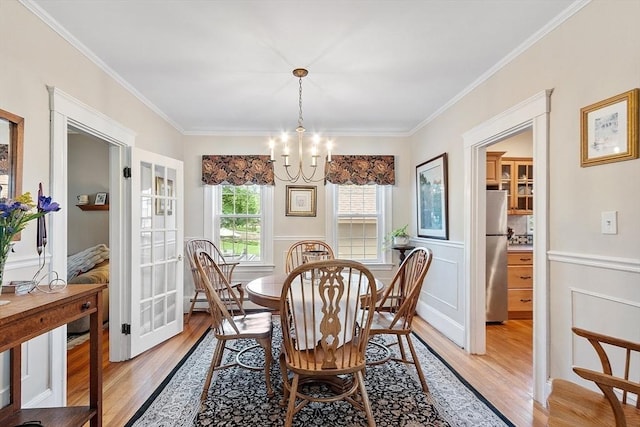4 Pleasant View St, Methuen, MA 01844 - dining room with light wood-type flooring, crown molding, a chandelier, and a wainscoted wall