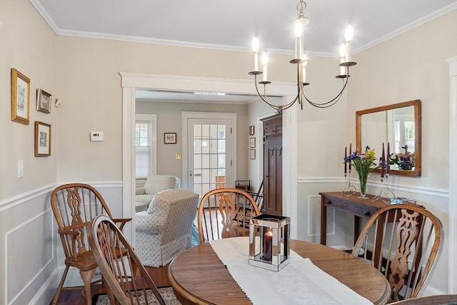 4 Pleasant View St, Methuen, MA 01844 - dining space with crown molding, a wainscoted wall, a decorative wall, and a chandelier
