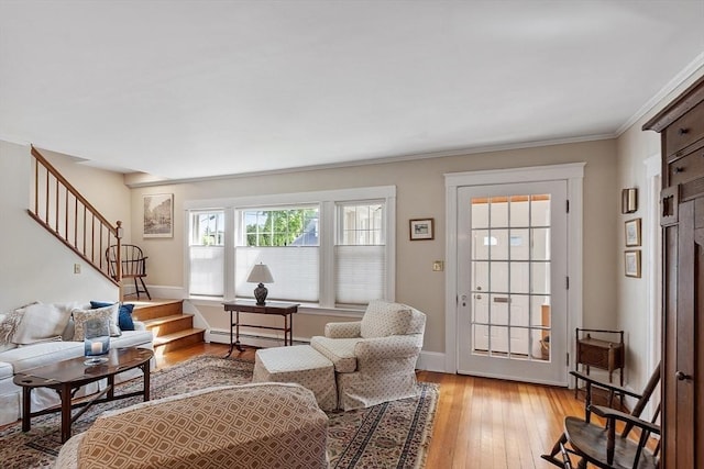 4 Pleasant View St, Methuen, MA 01844 - living room with stairs, light wood-style floors, a baseboard heating unit, ornamental molding, and baseboards