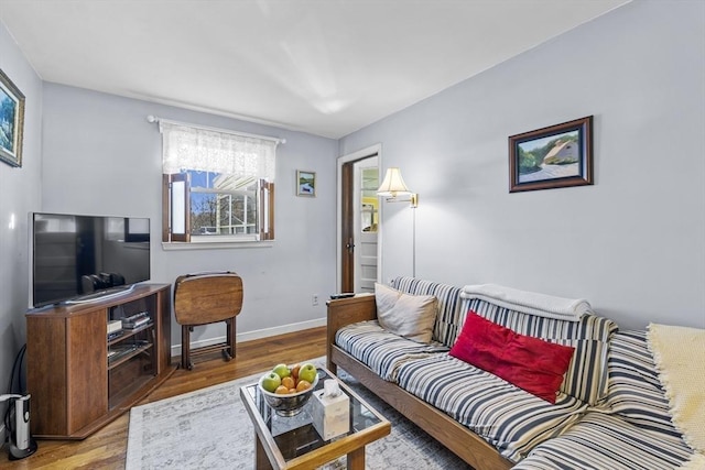 living room with wood finished floors and baseboards