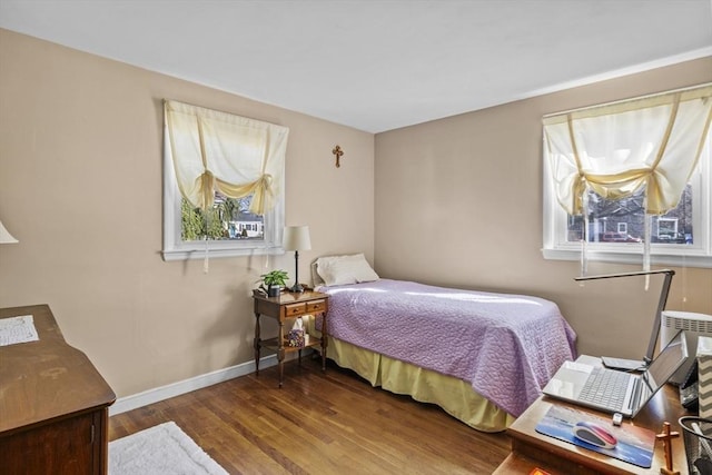 bedroom featuring wood finished floors and baseboards