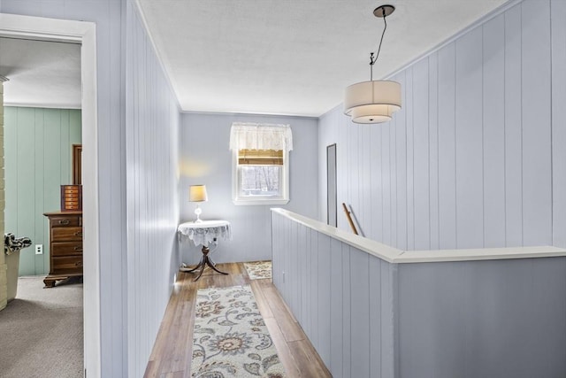 hall featuring an upstairs landing and light wood-type flooring