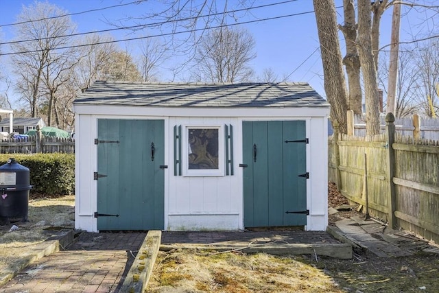 view of shed featuring fence