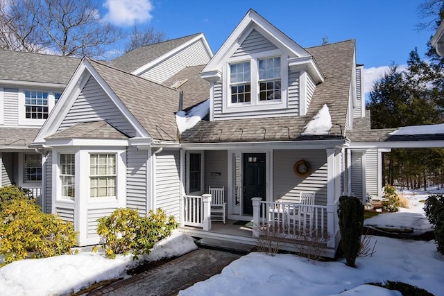 view of front of home with a shingled roof and covered porch