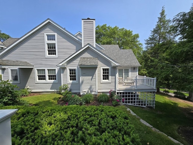 26 Highcroft Way Unit 26, Hopkinton, MA 01748 - rear view of property featuring a wooden deck, a chimney, a lawn, and roof with shingles