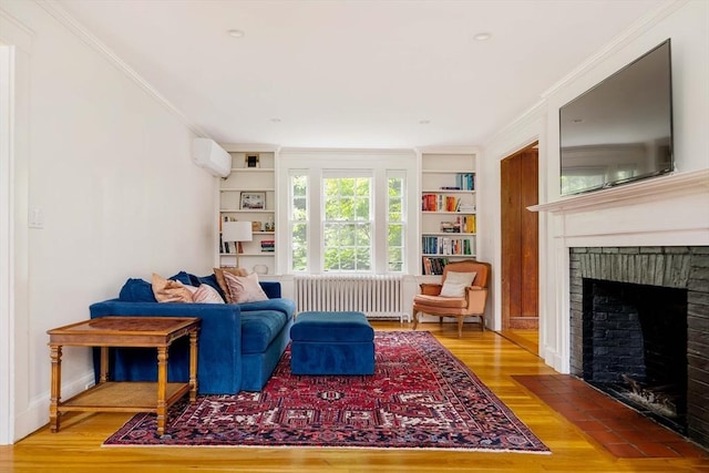96 Nonantum St, Newton, MA 02458 - living room with radiator heating unit, a fireplace, ornamental molding, built in features, and an AC wall unit
