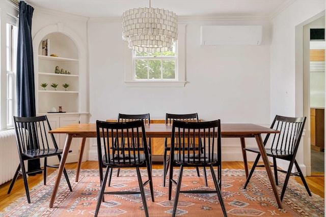96 Nonantum St, Newton, MA 02458 - dining space with a wall mounted AC, crown molding, light wood-style flooring, a chandelier, and built in features