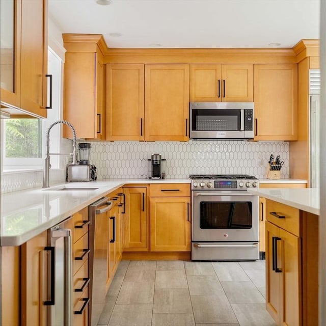 96 Nonantum St, Newton, MA 02458 - kitchen with stainless steel appliances, light countertops, a sink, tasteful backsplash, and beverage cooler