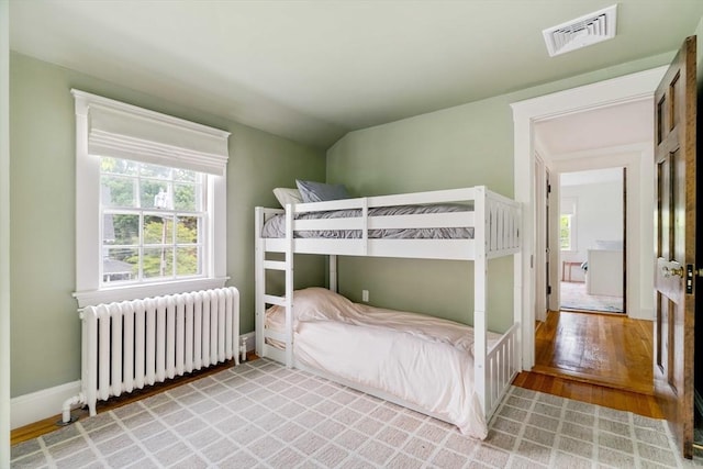 96 Nonantum St, Newton, MA 02458 - bedroom with radiator, light wood-style floors, and baseboards