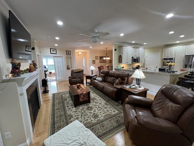 living room featuring ornamental molding and ceiling fan