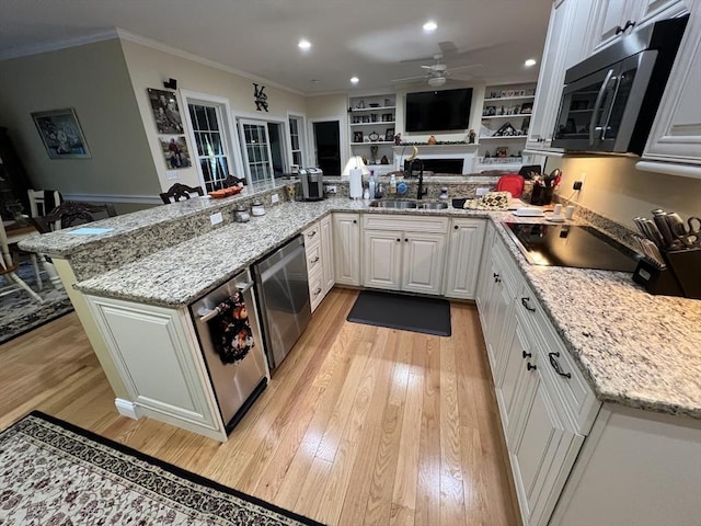 kitchen with sink, dishwasher, white cabinets, black electric cooktop, and kitchen peninsula