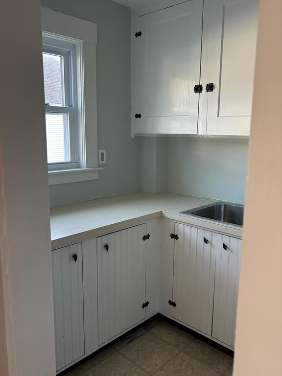 kitchen with white cabinetry and sink