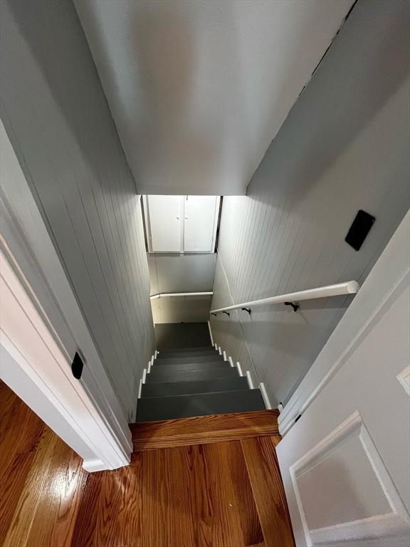 staircase with wood finished floors