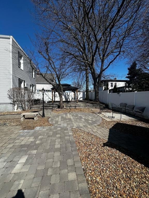 exterior space featuring decorative driveway
