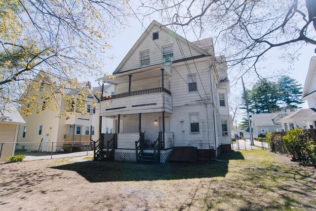 back of house with fence and a balcony