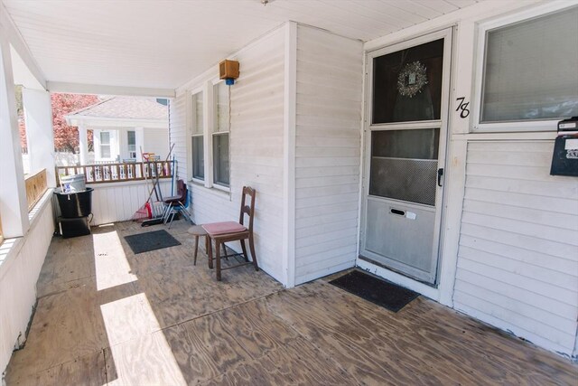 view of exterior entry featuring a porch