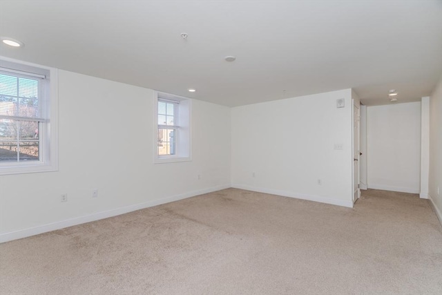 spare room with light carpet and a wealth of natural light