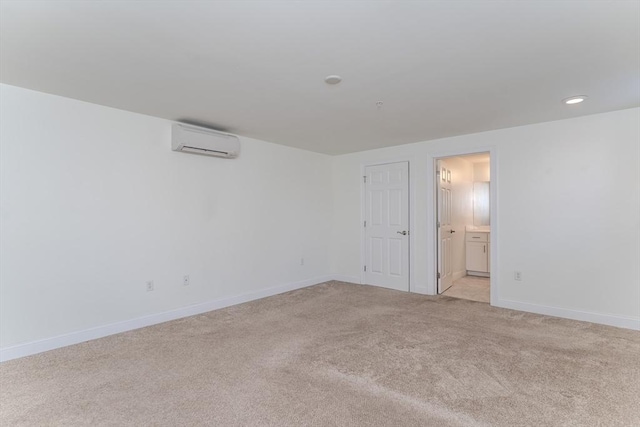 empty room featuring an AC wall unit and light carpet