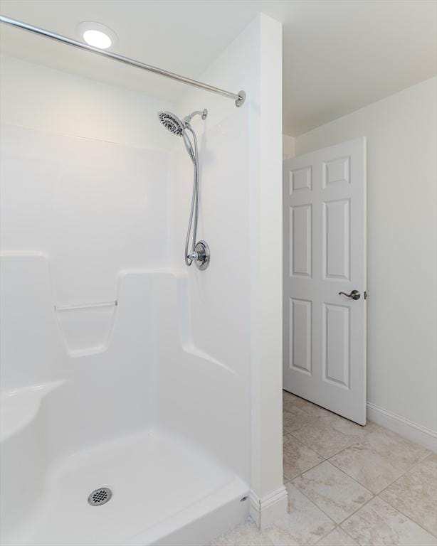 bathroom with a shower and tile patterned floors