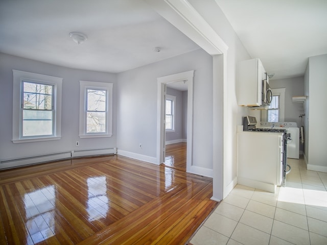 unfurnished dining area featuring light hardwood / wood-style floors and baseboard heating