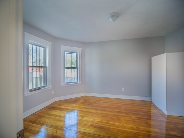 empty room with light hardwood / wood-style flooring