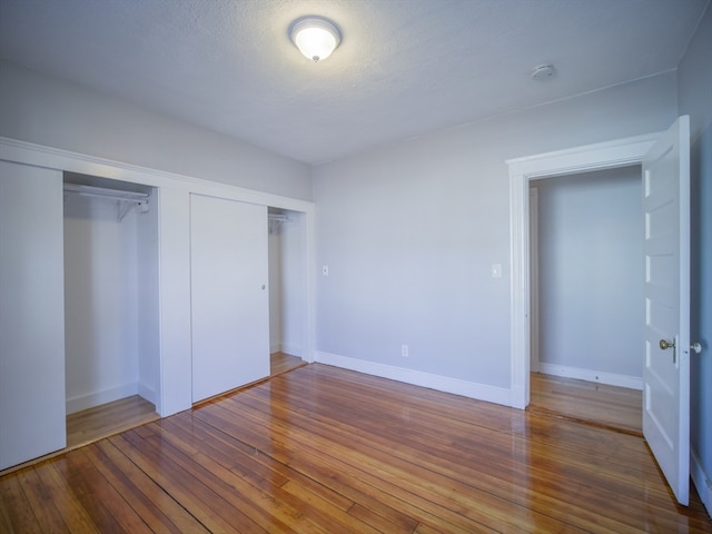 unfurnished bedroom featuring hardwood / wood-style floors and a textured ceiling