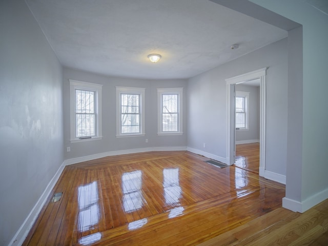 unfurnished room with hardwood / wood-style flooring