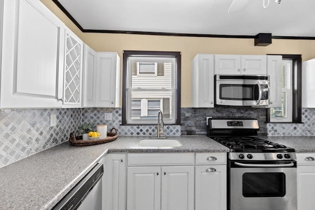 kitchen featuring appliances with stainless steel finishes, a sink, and white cabinets