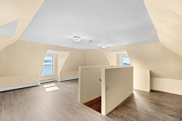 bonus room with vaulted ceiling and wood finished floors