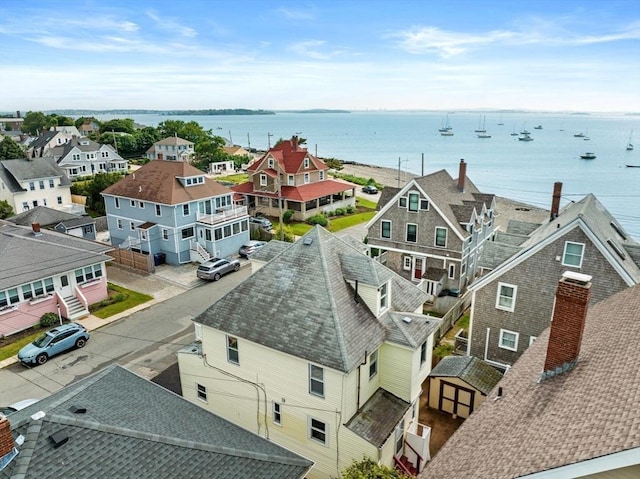 birds eye view of property with a water view and a residential view