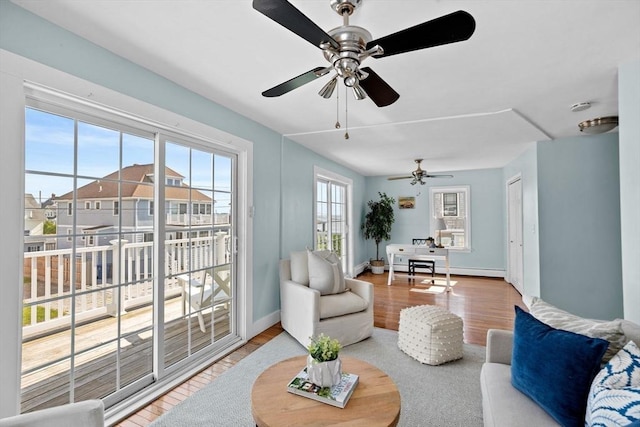 living room with baseboards and wood finished floors