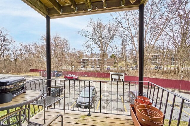 wooden deck featuring a grill