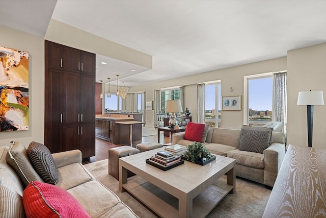 living room with a notable chandelier and light hardwood / wood-style floors