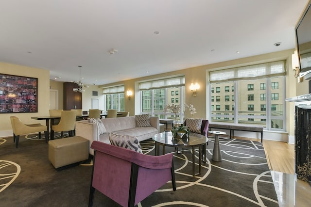 living room featuring concrete flooring and a chandelier