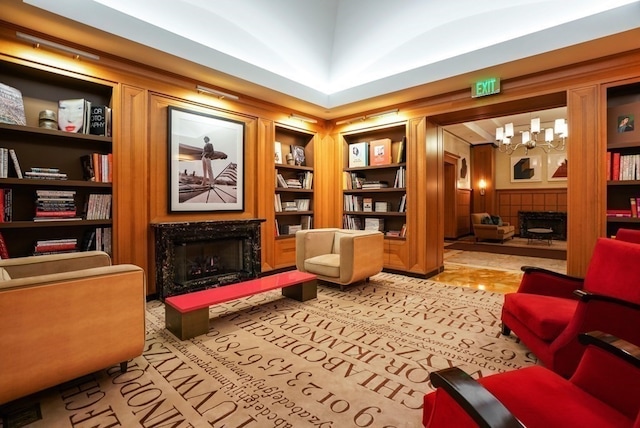 sitting room with light carpet, a premium fireplace, and built in features