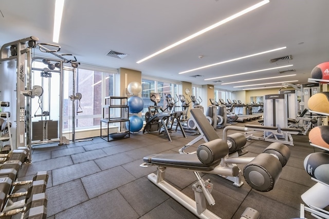 gym with a wall of windows