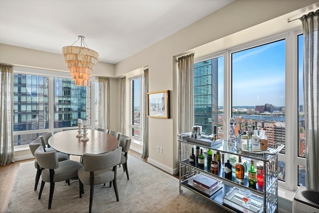 dining space featuring hardwood / wood-style flooring and a notable chandelier