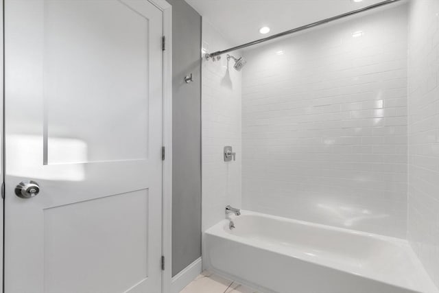 bathroom featuring tile patterned floors and tiled shower / bath