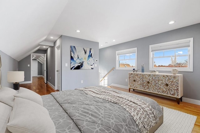 bedroom featuring lofted ceiling and hardwood / wood-style flooring