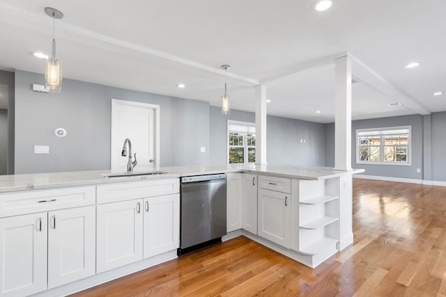 kitchen featuring white cabinetry, dishwasher, sink, a healthy amount of sunlight, and hanging light fixtures