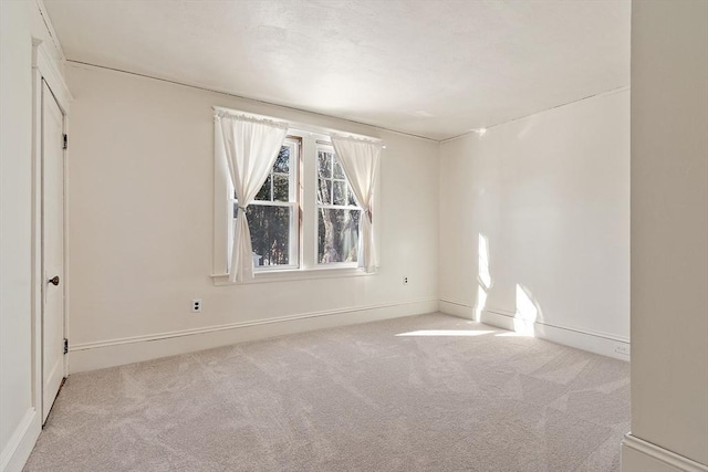 empty room with carpet floors and baseboards