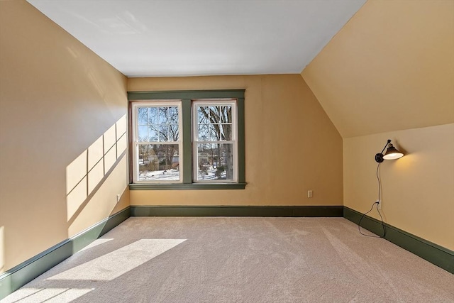 bonus room with vaulted ceiling, carpet flooring, and baseboards