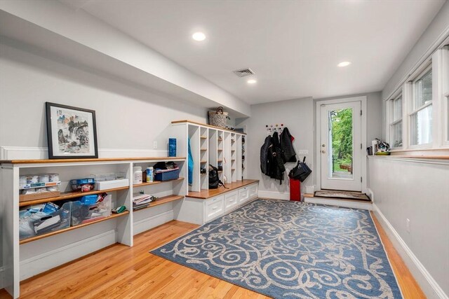 mudroom with light wood finished floors, recessed lighting, and baseboards