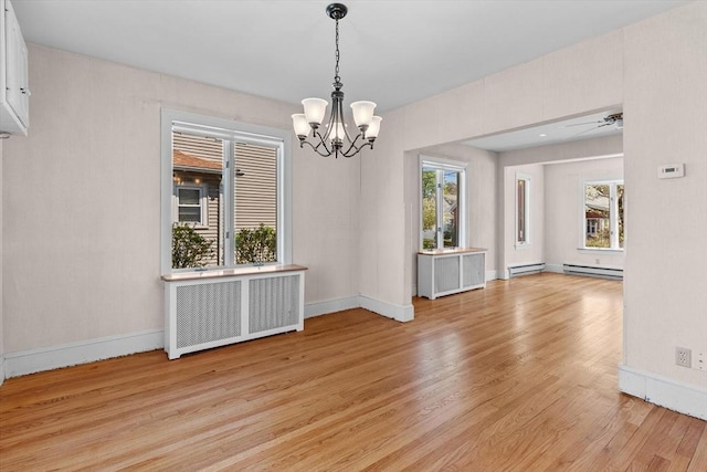 unfurnished dining area with baseboard heating, radiator, and light wood-style floors